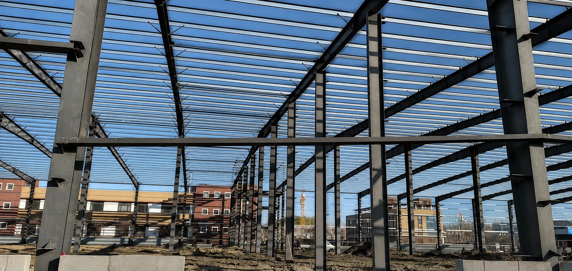 Steel structural frame of an industrial building against the sky