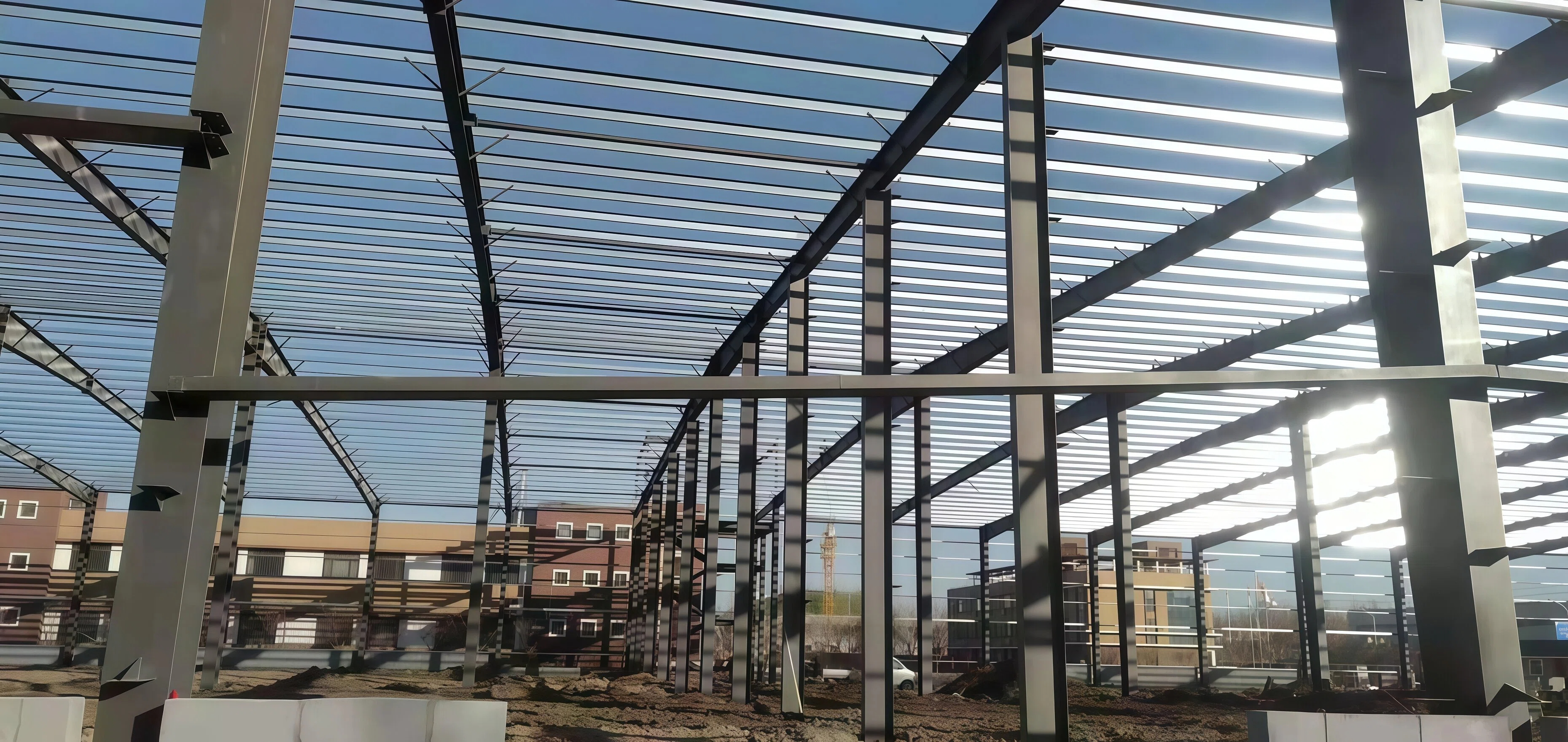 Steel structural frame of an industrial building against a clear sky