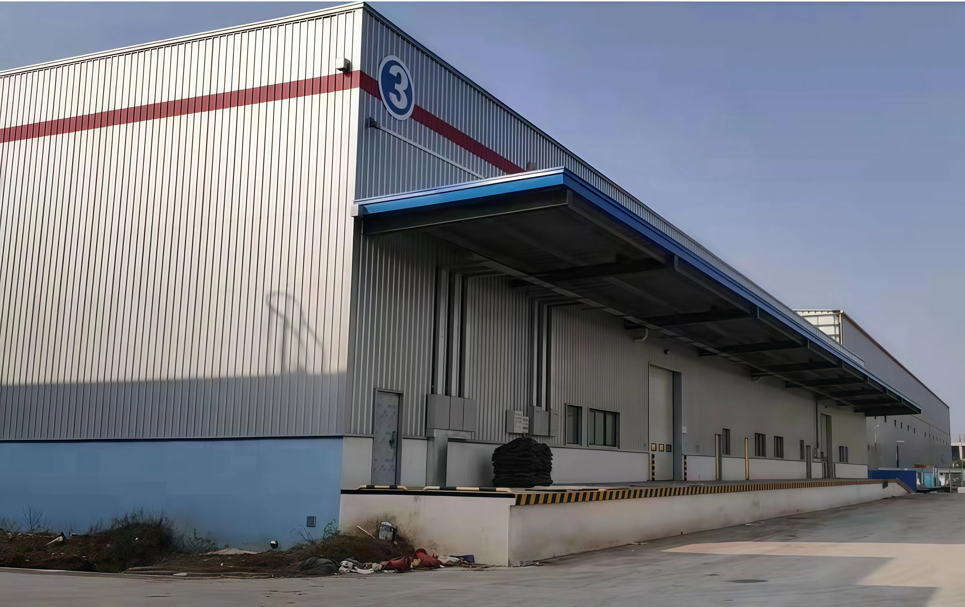 Completed industrial warehouse building exterior with loading dock